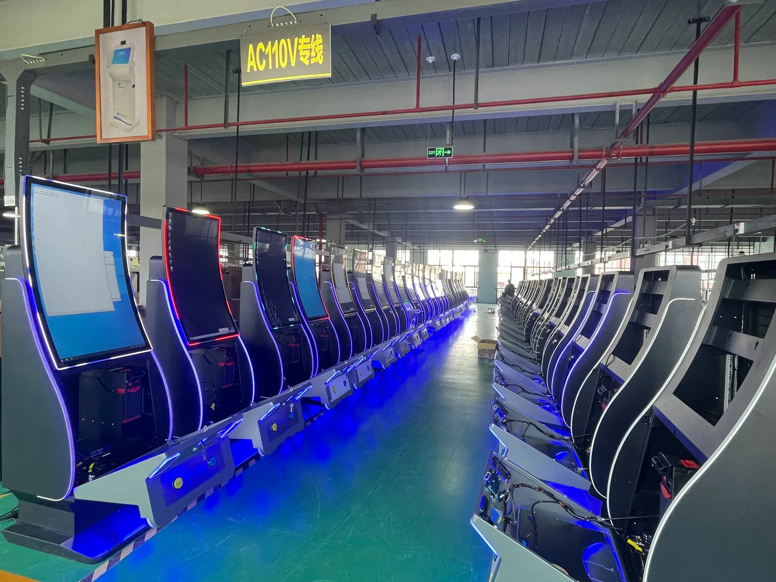 Rows of curved-screen gaming cabinets on the Usingwin production floor