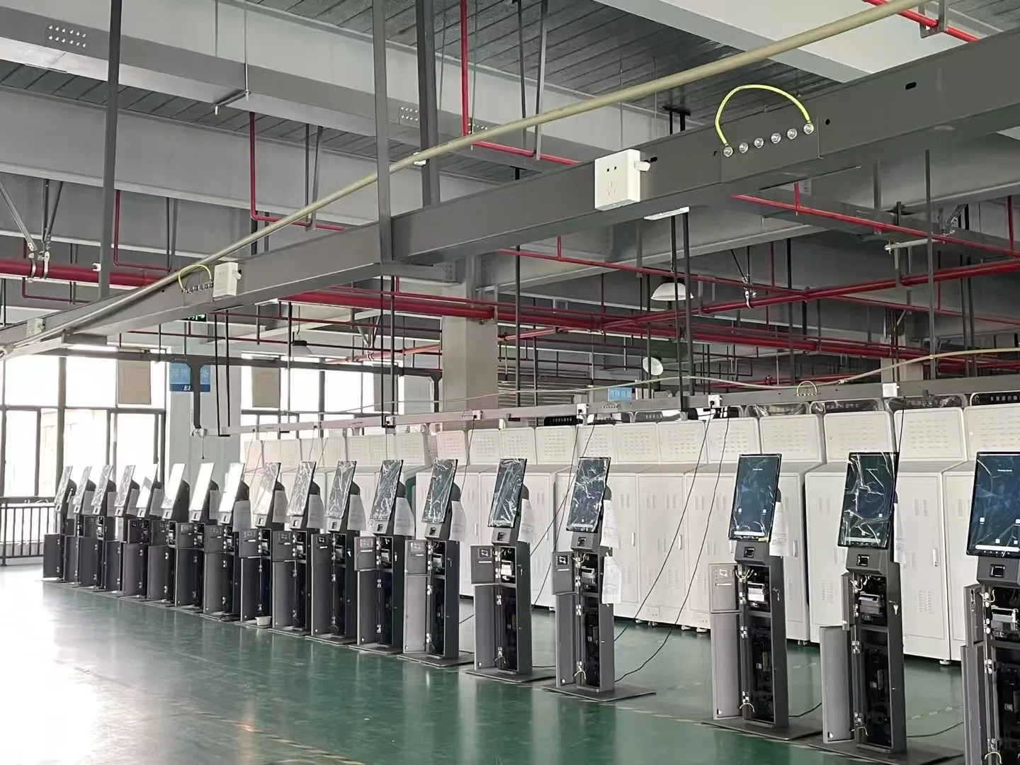 Self-service ordering kiosks undergoing assembly and testing at the factory